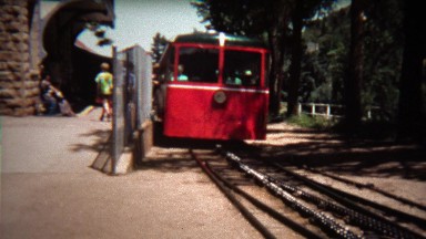 1972: Pikes Peak cog railway leaving station towards mountain peak.
