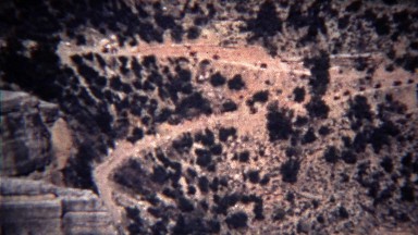 1972: Line of horse riders coming down steep mountain hiking trail.