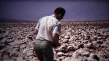 1972: Man Tasting Ground Salt in Dried Desert Lake Bed