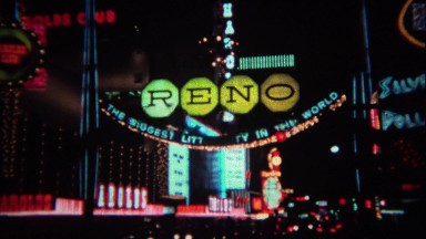 1971: Colorful hotel casino lights at night sparkling and flashing.