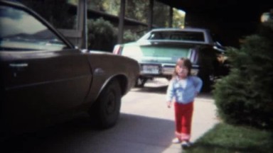 1970: Baby sister meeting Mom and newborn baby brother at car.