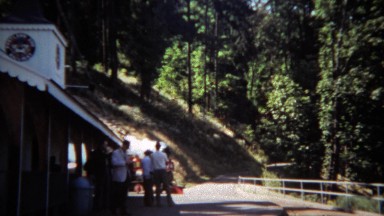 1971: Mini steam powered railroad train ride taking corner.