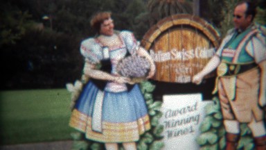 1971: Couple posing at winery in comedy cut out funny business.