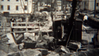 1939: Steam Shovel and Crane Moving Concrete After Disaster