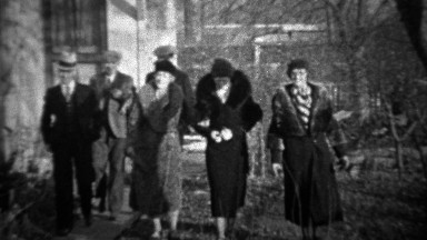 1933: Men greeting women tipping cap bowing to pretty wifes.