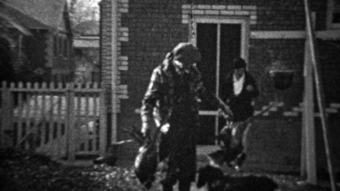 1935: Proud man shows dead pheasant birds in residential front porch.