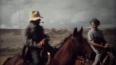 1940: Pipe Smoking Cowboy and Wife Riding Horses on the Range