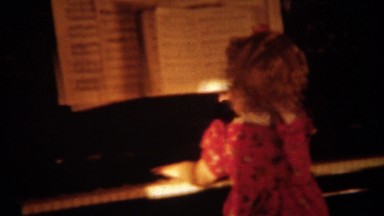 1940: Curly Haired Girl Playing Piano in Denver, Colorado