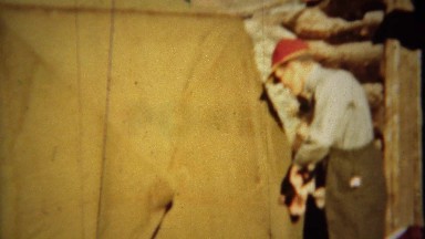 1939: Camper Breaking Down Canvas Tent and Removing Hunting Gun at Grand Lake, Colorado
