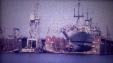 1956: Dry docked container cargo ship repairs made in harbor.