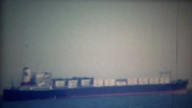 1956: Full Cargo Container Ship Heading Out to Open Ocean Water