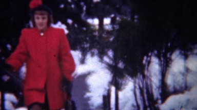 1948: Formal red coat fashion dress on wealthy women in wintertime.