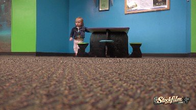 Denver, Colorado, United States: Toddler Walking From Kids Table Across Carpet Floor To Camera.