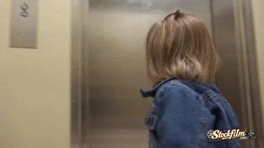 Denver, Colorado, United States: Mom Holding Elevator Door for Toddler Entering Hospital Hallway.