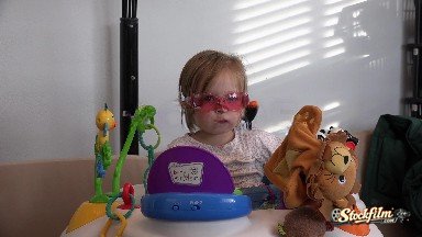 Denver, Colorado, United States: Toddler Takes Off Rose Colored Glasses in Baby Einstein Office.