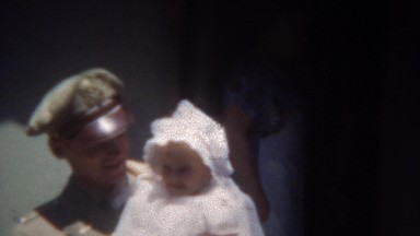 1949: Military uniformed hero back from service holding newborn infant baby.