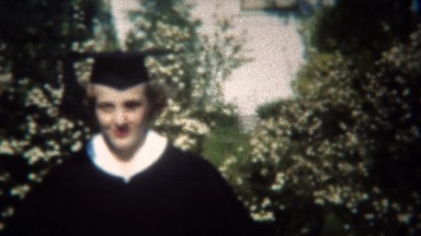 1949: College graduate in classic black and white gown and cap.