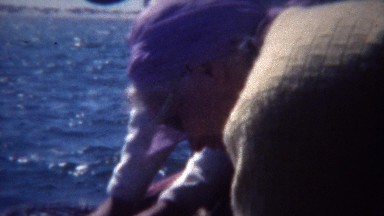 1949: Dungeness crab catching net from boat in ocean bay waters.