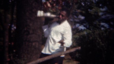 1944: African waiter chef serving fancy food tray to wealthy patrons.