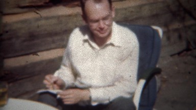 1944: Man taking notes as women smoking cigarette dictates thoughts.