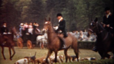 1944: Fox hunting equestrian horse riding expo trotting around track.