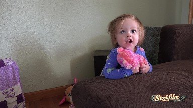Toddler Hugs Pink Stuffed Animal Bear Toy on Brown Family Couch. Denver,