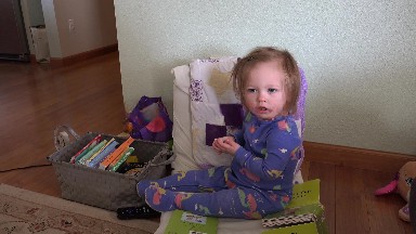 Baby pulling out hair clip from head of long brown blonde hair. DENVER, COLORADO