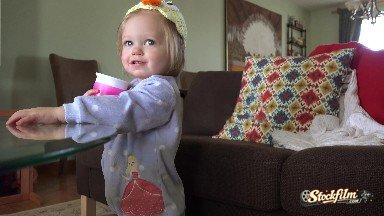 Baby with Homemade Duck Hat Drinking from Pink Sippy Cup. Denver, Colorado