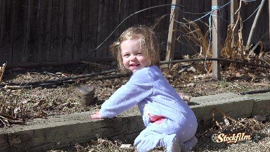 Baby Kneeling Outside Sunny Playing With Garden Backyard Rocks. Denver, Colorado