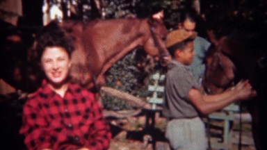1943: Woman in Flannel Shirt Horse Riding Prepared by Teenage Worker, Tryon, NC