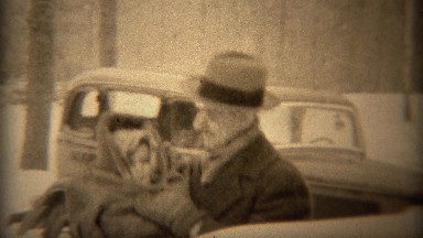 1937: Proud dad bundled up baby keeping warm in cold winter weather. TRYON, NC