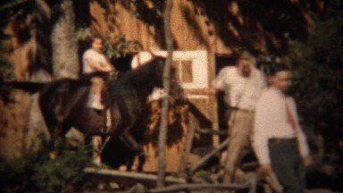 1937: Young girl 1st time riding horse helped by proud trainer and father.