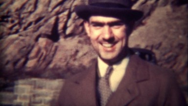 1939: Fedora Hat Man Smiles and Walks to Parked Classic Lincoln Car, Tryon, NC