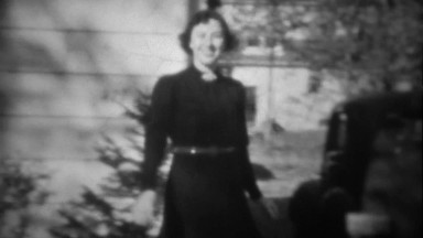 1939: Femme Fatale Woman in Black Tries on Man's Hat in Funny Gag, Tryon