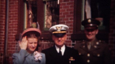 1944: Military men in decorated uniforms with new wife in proper lady attire.