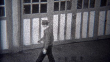 1944: Man opening garage door driving out classic Buick car. MIAMI, FLORIDA