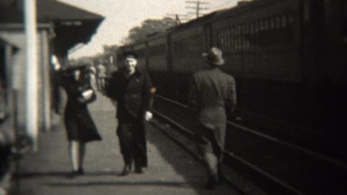 1947: Happy US Navy man train station with fashionable dame.