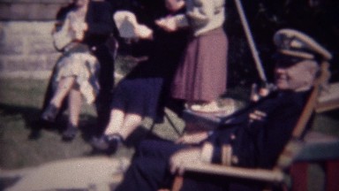 1947: US Navy admiral served afternoon cocktail at outdoor party.