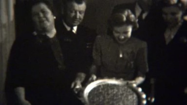 1947: Grateful family gets shiny silver serving platter holiday gift.