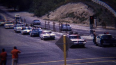 1972: Parade of little league baseball players driving to tournament.