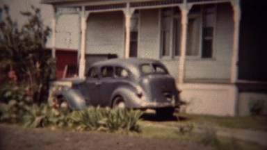 1962: Classic gray Dodge car parked suburban house driveway.