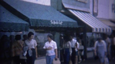 1962: Shoppers walking past boardwalk The Needlecraft store.