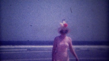 1949: Women Wearing Tall Funny Sun Hats Walking on Ocean Beach