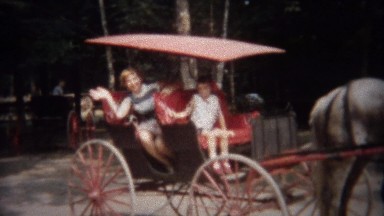 1949: Horse drawn carriage takes waving family on city tour.