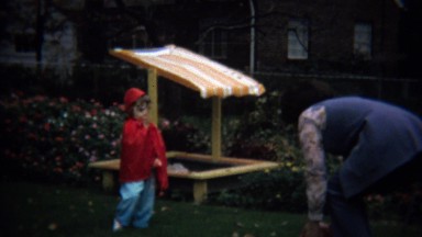 1973: Mom Playing Ball Catch with Red Riding Hood Toddler Daughter.