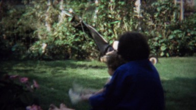 1973: Mom Rocks Toddler in Backyard Play Game Backwards