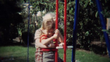 1971: Brother and Sister Playing on Seesaw in Backyard Playground