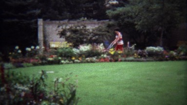 1974: Mother Pushing Stroller Through Flower-Blossom Conservatory