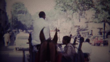 1973: Horse carriage ride pov busy arab crowded street.