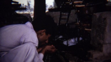 1973: Arab man hand drinking primitive water well.